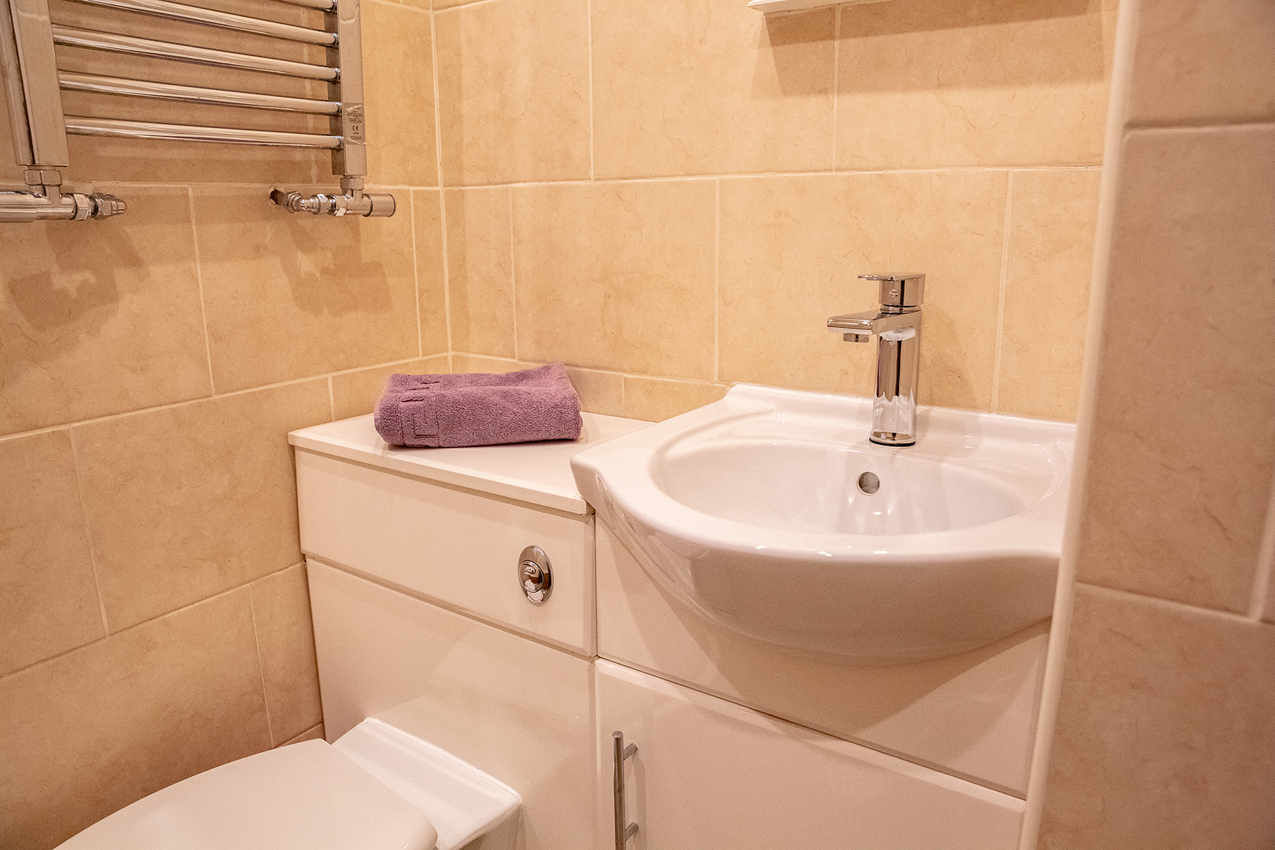 A clean bathroom with a face towel folded neatly on show